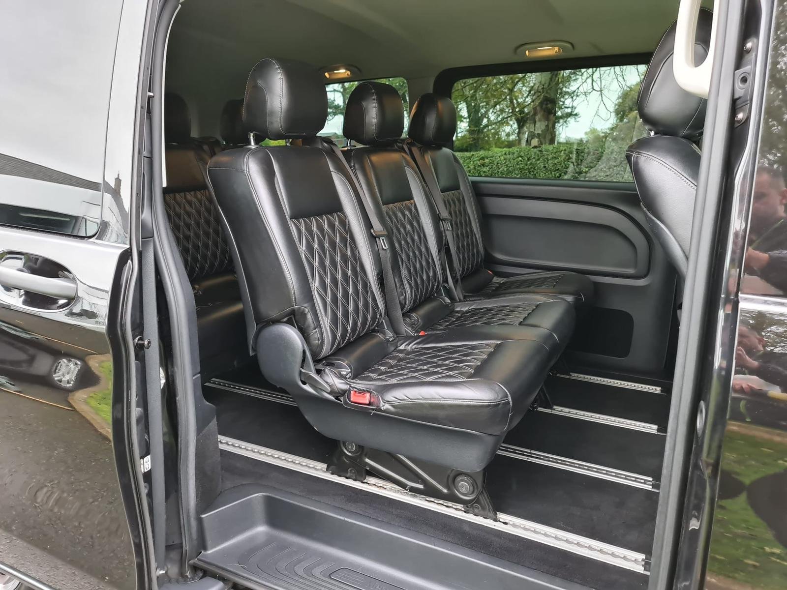 Black leather diamond stitched rear seats in luxury vehicle