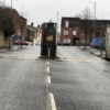 Peace wall gate dividing a residential street in Belfast on a cloudy day